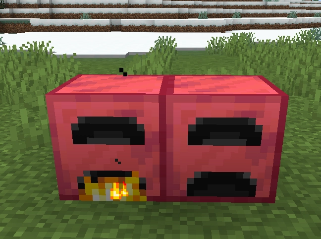 Two Ruby Furnace Block next to each other, the left one in a lit and the right one in an unlit blockstate